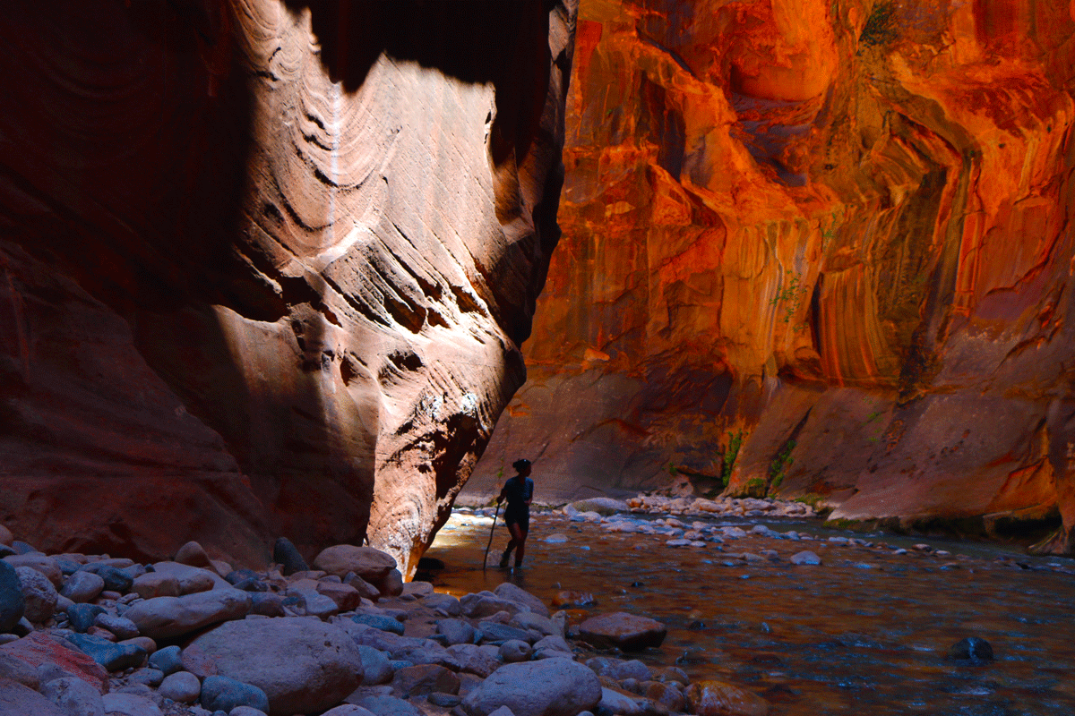 Female hiking with drastic red glow in the Narrows