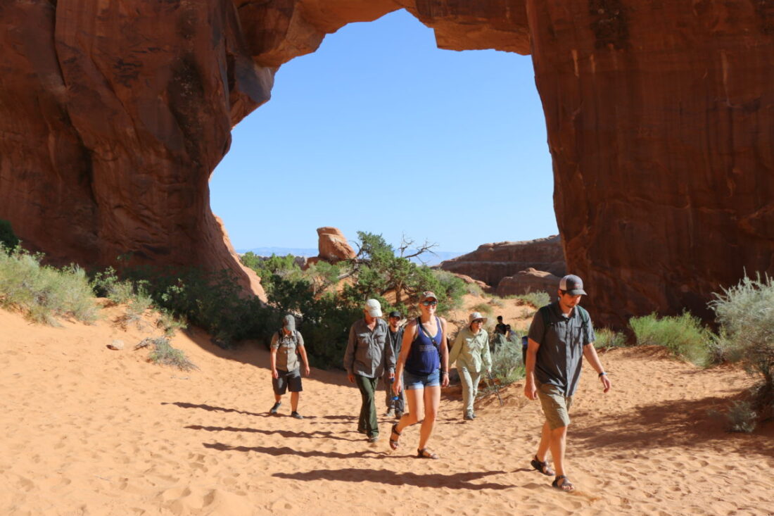 Justin Ebert hiking in sand with group